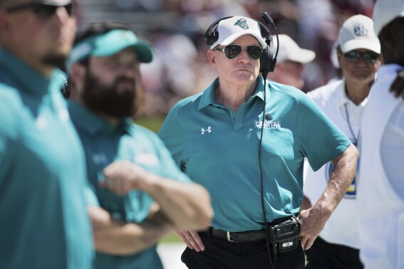 FILE - Coastal Carolina coach Joe Moglia watches from the sideline during the team's NCAA college football game against South Carolina on Sept. 1, 2018, in Columbia, S.C. Coastal Carolina's Matt Hogue, in charge of the athletic department for the past 10 years, will move to a new role at the school this summer while former football coach Moglia will give up his positions as chairman of athletics and executive director of football once the new athletic director is hired. (AP Photo/Sean Rayford, File)