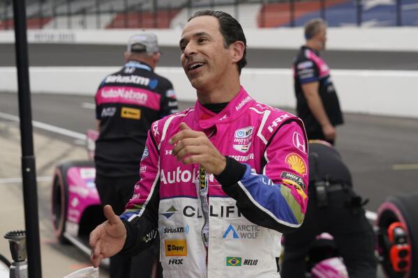 Helio Castroneves, of Brazil, talks with his crew during qualifications for the IndyCar Grand Prix auto race at Indianapolis Motor Speedway, Friday, May 12, 2023, in Indianapolis. (AP Photo/Darron Cummings)