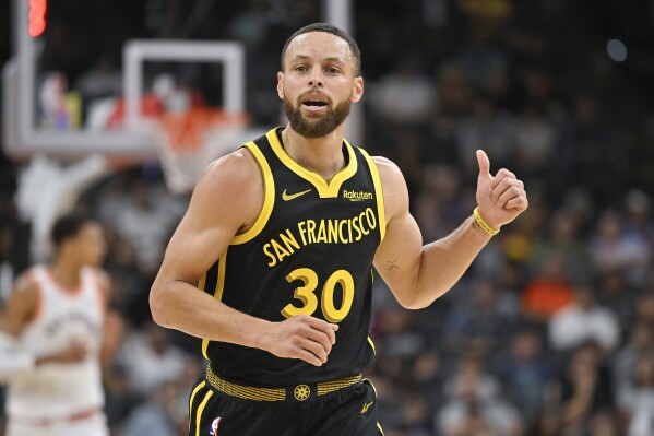 Golden State Warriors' Stephen Curry runs upcourt during the first half of the team's NBA basketball game against the San Antonio Spurs, Sunday, March 31, 2024, in San Antonio. (AP Photo/Darren Abate)