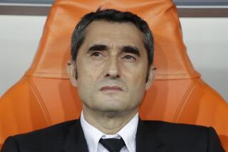 FILE - Barcelona's head coach Ernesto Valverde sits on the bench prior the Spanish Super Cup semifinal soccer match between Barcelona and Atletico Madrid at King Abdullah stadium in Jiddah, Saudi Arabia, on Jan. 9, 2020. Bilbao's coach Ernesto Valverde is officially back as Athletic Bilbao’s coach. The Spanish club made the announcement five days after new president Jon Uriarte was elected and pledged to bring Valverde back for his third stint as the team’s coach. The 58-year-old Valverde has not coached since he was fired from Barcelona in January 2020. (AP Photo/Hassan Ammar)