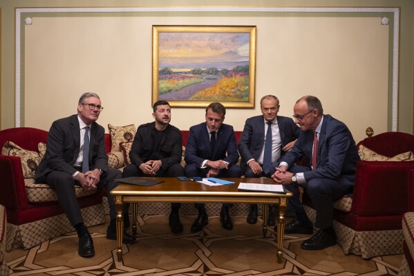 From left, British Prime Minister Keir Starmer, President Volodymyr Zelenskyy, French President Emmanuel Macron, Polish Prime Minister Donald Tusk and German Chancellor Friedrich Merz make a call to U.S. President Donald Trump from Kyiv, Ukraine, on Saturday, May 10, 2025. (AP Photo/Mstyslav Chernov)
