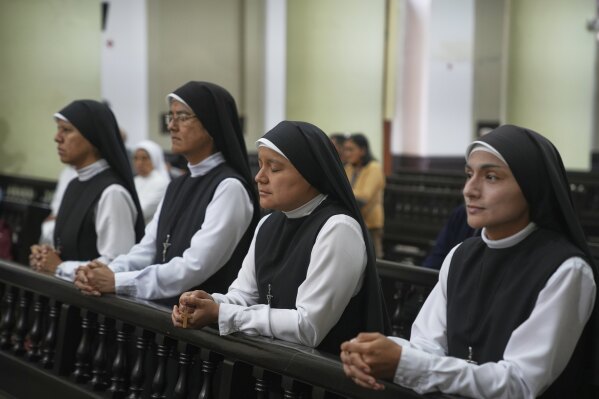 Nuns pray during morning Mass at the Santa Maria Cathedral, the episcopal see of the Diocese of Chiclayo, Peru, where newly elected Pope Leo XIV served as bishop, Friday, May 9, 2025. (AP Photo/Guadalupe Pardo)