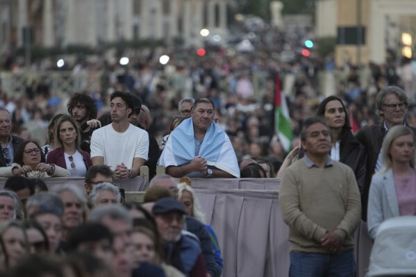 Faithful gather for a rosary prayer for the late Pope Francis, in St. Peter's Square at the Vatican, Monday April 21, 2025. (AP Photo/Alessandra Tarantino)