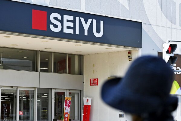 A company sign of Seiyu is seen in Hiratsuka, near Tokyo Monday, Nov. 16, 2020. U.S. retailer Walmart is selling off 85% of its wholly owned Japanese supermarket subsidiary Seiyu, while retaining a 15% stake, in a deal valued at ¥172.5 billion ($1.6 billion), the companies said Monday. (Kyodo News via AP)