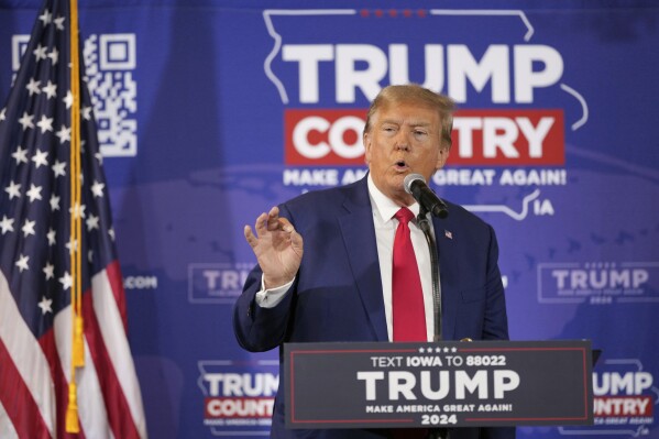 FILE - Former President Donald Trump speaks during a Commit to Caucus rally, Saturday, Dec. 2, 2023, in Ankeny, Iowa. Experts in political messaging say former President Donald Trump’s remarks that his supporters must “guard the vote” in 2024 are potentially dangerous and could lead to confrontations at polling place. (AP Photo/Matthew Putney, File)