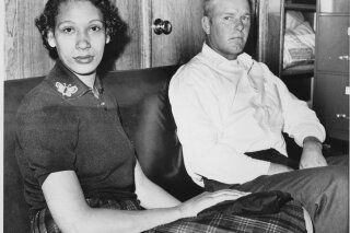 
              This Jan. 26, 1965 file photo shows Mildred Loving and her husband Richard P Loving.  Fifty years after Mildred and Richard Loving’s landmark legal challenge shattered the laws against interracial marriage in the U.S., some couples of different races still talk of facing discrimination, disapproval and sometimes outright hostility from their fellow Americans.  (AP Photo)
            