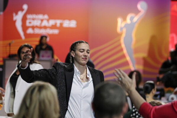 Louisville's Emily Engstler reacts after being selected by the Indiana Fever as the fourth overall pick in the WNBA basketball draft, April 11, 2022, in New York.  (AP Photo/Adam Hunger, file)