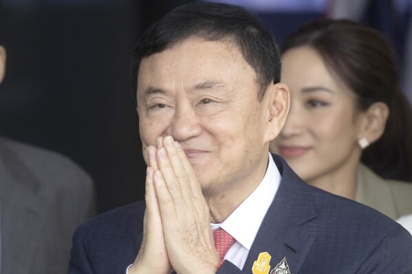 FILE - Thailand's former Prime Minister Thaksin Shinawatra greets his supporters as he arrives at Don Muang airport in Bangkok, Thailand, Tuesday, Aug. 22, 2023. Thailand's king granted former prime minister Thaksin a pardon and reduced his eight-year prison sentence to one year, just over a week after the business tycoon-turned-politician returned from 15 years of self-imposed exile. The pardon granted by King Maha Vajiralongkorn was published Friday, Sept. 1, 2023, in the Royal Gazette, making it effective immediately. (AP Photo/Wason Wanichakorn, file)