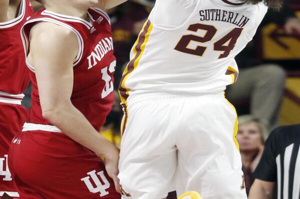Minnesota guard Sean Sutherlin (24) tries to shoot as Indiana forward Miller Kopp (12) defends him in the second half of an NCAA college basketball game Sunday, Feb. 27, 2022, in Minneapolis. Indiana won 84-79. (AP Photo/Bruce Kluckhohn)