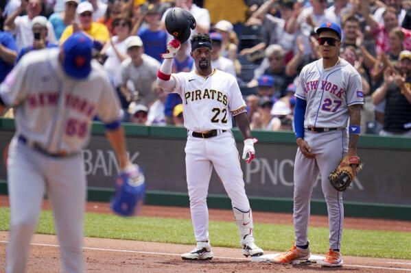 Pittsburgh Pirates' Andrew McCutchen (22) stands on first base after hitting a single off New York Mets starting pitcher Carlos Carrasco, left, for his 2000th major league hit during the first inning of a baseball game in Pittsburgh, Sunday, June 11, 2023. (AP Photo/Gene J. Puskar)