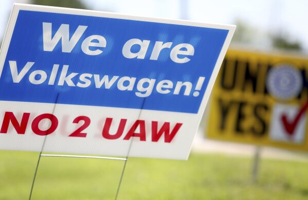 Signs for and against unionization are in a roundabout along Volkswagen Drive in front of the Volkswagen plant Friday, June 14, 2019 in Chattanooga, Tenn. Workers voted against forming a factory-wide union, handing a setback to the United Auto Workers’ efforts to gain a foothold among foreign auto facilities in the South. (Erin O. Smith/Chattanooga Times Free Press via AP)
