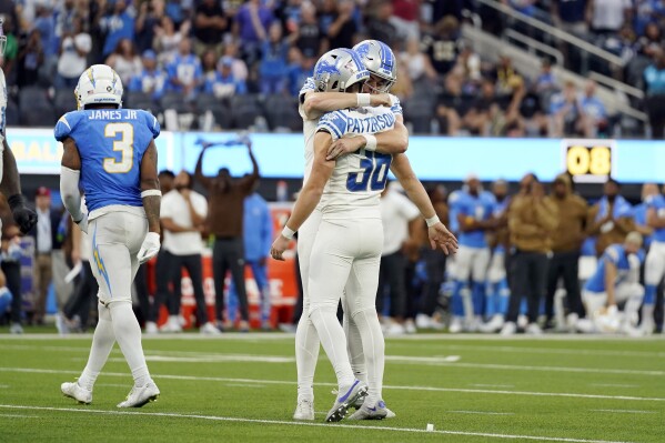 Detroit Lions place kicker Riley Patterson (36) is hugged by placed holder Jack Fox (3) after Patterson made the game-winning field goal as time expired during an NFL football game against the Los Angeles Chargers Sunday, Nov. 12, 2023, in Inglewood, Calif. (AP Photo/Ashley Landis)