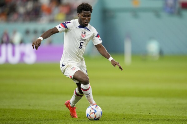 FILE - Yunus Musah of the United States dribbles the ball during their World Cup soccer match against the Netherlands, at the Khalifa International Stadium in Doha, Qatar, Saturday, Dec. 3, 2022. Musah is following United States teammate Christian Pulisic to American-owned AC Milan. Musah, who was born in New York but grew up in Italy and England, signed a five-year contract with the Rossoneri on Friday, Aug. 4, 2023 following a transfer from Valencia. (AP Photo/Ashley Landis, file)