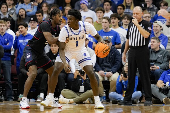 Seton Hall guard Kadary Richmond (1) posts up UConn guard Tristen Newton during the first half of an NCAA college basketball game in Newark, N.J., Wednesday, Dec. 20, 2023. (AP Photo/Peter K. Afriyie)