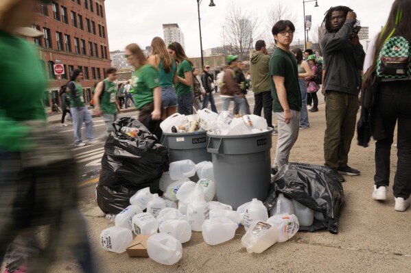Empty containers used for homemade drinks overflow the garbage cans after the St. Patrick's Day parade, Sunday, March 16, 2025, in Boston, Mass. (AP Photo/Robert F. Bukaty)