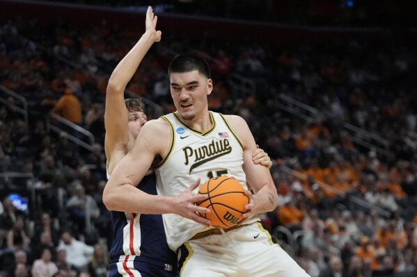 Purdue center Zach Edey (15) is defended by Gonzaga forward Ben Gregg during the second half of a Sweet 16 college basketball game in the NCAA Tournament, Friday, March 29, 2024, in Detroit. (AP Photo/Paul Sancya)