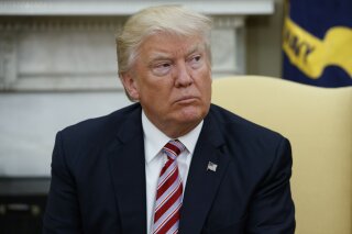 FILE - In this May 10, 2017 file photo, President Donald Trump talks to reporters in the Oval Office of the White House in Washington. Trump, in an apparent warning to his fired FBI director, said Friday, May 12, 2017, that James Comey had better hope there are no "tapes" of their conversations. Trump's tweet came the morning after he asserted Comey had told him three times that he wasn't under FBI investigation. (AP Photo/Evan Vucci, File)