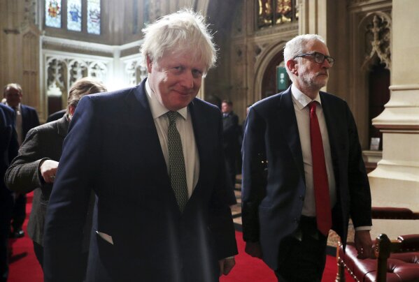 FILE - In this Thursday, Dec. 19, 2019 file photo, Prime Minister Boris Johnson, foreground, and Labour Party leader Jeremy Corbyn arrive for the State Opening of Parliament at the Houses of Parliament in London. Britain's Queen Elizabeth II formally opened the new session of Parliament after Johnson's Conservatives won a big majority in a general election of Dec. 12, 2019 with a promise to "Get Brexit Done." Britain leaves the European Union on Friday, Jan. 31, 2020 after 47 years of membership. (Hannah McKay/Pool via AP/File)