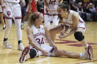 Indiana's Grace Berger (34) reacts with Mackenzie Holmes after Berger took a charging foul during the first half of the team's NCAA college basketball game against Ohio State, Thursday, Jan. 26, 2023, in Bloomington, Ind. (AP Photo/Darron Cummings)