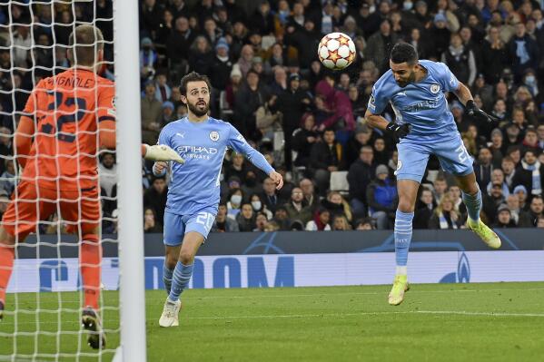Manchester City's Riyad Mahrez, right, scores his side's second goal during the Champions League Group A soccer match between Manchester City and Club Brugge at the Etihad stadium, in Manchester, England, Wednesday Nov. 3, 2021. (AP Photo/Rui Vieira)