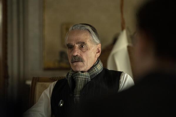 This image released by Netflix shows  Jeremy Irons as Neville Chamberlain in a scene from "Munich: The Edge of War." (Frederic Batier/Netflix via AP)