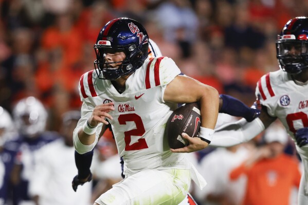 Mississippi quarterback Jaxson Dart (2) carries the ball in for a touchdown against Auburn during the first half of an NCAA college football game, Saturday, Oct. 21, 2023, in Auburn, Ala. (AP Photo/Butch Dill)