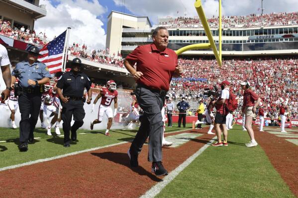 Arkansas coach Sam Pittman leads his team onto the field to play Georgia Southern during the first half of an NCAA college football game Saturday, Sept. 18, 2021, in Fayetteville, Ark. (AP Photo/Michael Woods)