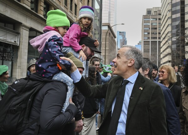 Prime Minister Mark Carney greets members of the crowd during the annual St. Patrick's Day Parade in Montreal, Sunday, March 16, 2025.(Graham Hughes /The Canadian Press via AP)