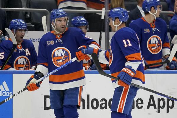 New York Islanders center Kyle Palmieri (21) celebrates with left wing Zach Parise (11) after scoring on New York Rangers goaltender Jaroslav Halak (41) in the second period of an NHL hockey game, Wednesday, Oct. 26, 2022, in Elmont, N.Y. (AP Photo/John Minchillo)