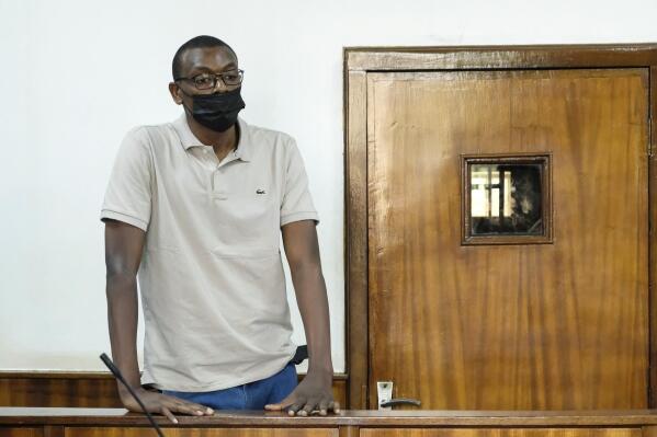 Kakwenza Rukirabashaija, displaying scars on his arm and charging that he was tortured for weeks while in detention, appears before a court in a failed bid to have his passport returned so he could seek medical treatment abroad, at a court in Kampala, Uganda on Tuesday, Feb. 1, 2022. The European Union and the United States are raising alarm over torture allegedly perpetrated by Uganda's security forces, with the prominent writer and government critic saying that he is a recent victim. (AP Photo/Hajarah Nalwadda)
