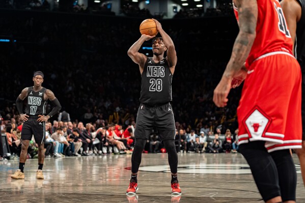 Brooklyn Nets' Dorian Finney-Smith (28) shoots a free throw during the second half of an NBA basketball game against the Chicago Bulls in New York, Friday, March 29, 2024. (AP Photo/Peter K. Afriyie)