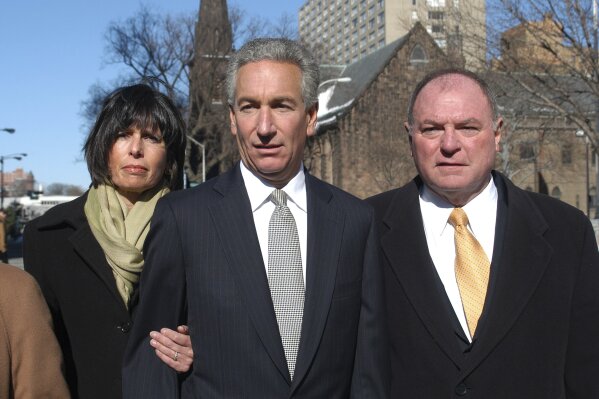 FILE - In this March 4, 2005 file photo, Charles B. Kushner, flanked by his wife, Seryl Beth, left, and his attorney Alfred DeCotiis arrives at the Newark Federal Court for sentencing in Newark, N.J. President Donald Trump on Wednesday, Dec. 23, 2020 issued pardons and sentence commutations for 29 people, including former campaign chairman Paul Manafort and Charles Kushner, the father of his son-in-law, in the latest burst of clemency in his final weeks at the White House. (AP Photo/Marko Georgiev, File)