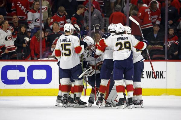 The Florida Panthers surround goaltender Sergei Bobrovsky following the team's win 3-2 win over the Carolina Hurricanes in four overtimes in Game 1 of the NHL hockey Stanley Cup Eastern Conference finals in Raleigh, N.C., early Friday, May 19, 2023. (AP Photo/Karl B DeBlaker)