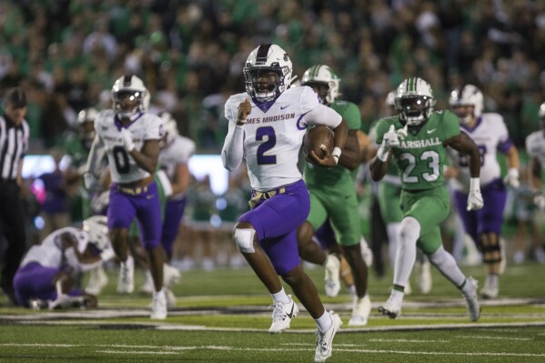 James Madison's Jordan McCloud (2) moves the ball on a run against Marshall during an NCAA college football game Thursday, Oct. 19, 2023, in Huntigton, W.Va. (Ryan FischerThe Herald-Dispatch via AP)