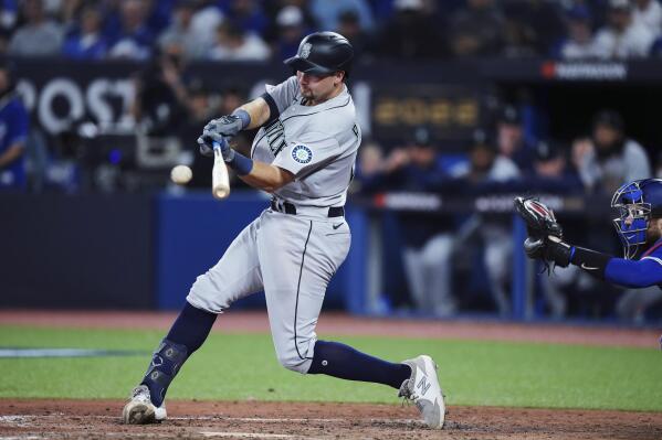 Seattle Mariners' Cal Raleigh hits an RBI single against the Toronto Blue Jays during the eighth inning of Game 2 of a baseball AL wild-card playoff series Saturday, Oct. 8, 2022, in Toronto. (Nathan Denette/The Canadian Press via AP)