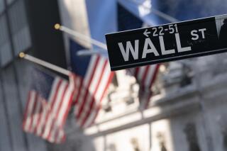 FILE -A sign for Wall Street hangs in front of the New York Stock Exchange, July 8, 2021.  Stocks are off to a mostly lower start on Wall Street Friday, Sept. 17,  as the market heads for a weak ending to an up-and-down week of trading.  (AP Photo/Mark Lennihan, file)