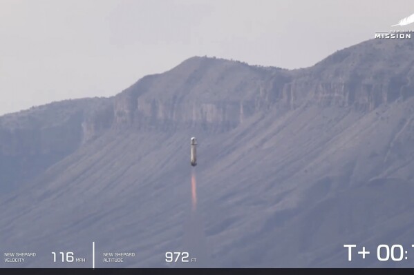 This image provided by Blue Origin shows the New Shepard rocket launching from West Texas on Tuesday, Dec. 19, 2023. Jeff Bezos' space company launched the rocket carrying experiments on Tuesday, its first flight since engine trouble caused a crash more than a year ago. (Blue Origin via AP)