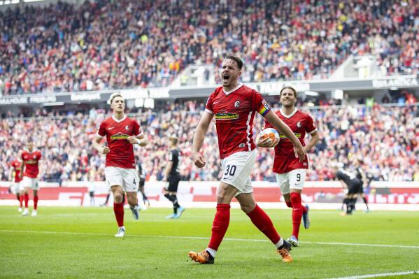 Freiburg's Christian Guenter celebrates after scoring his side's second goal during the German Bundesliga soccer match bettween SC Freiburg and Borussia Moenchengladbach in Freiburg, Germany, Saturday, April 23, 2022 (Tom Weller/dpa via AP)