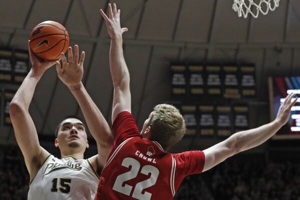 Purdue center Zach Edey (15) shoots the ball over Wisconsin forward Steven Crowl (22) during the NCAA men's basketball game, Sunday, March 10, 2024, at Mackey Arena in West Lafayette, Ind. Purdue won 78-70. (Alex Martin/Journal & Courier via AP)