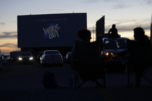 Using social distancing practices, moviegoers watch a show at the Stars and Stripes Drive-In Theater that reopened in New Braunfels, Texas, Friday, May 1, 2020. Texas' stay-at-home orders due to the COVID-19 pandemic have expired and Texas Gov. Greg Abbott has eased restrictions on many businesses that have now opened, including theaters. (AP Photo/Eric Gay)