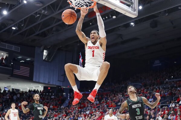 FILE - In this Dec. 17, 2019, file photo, Dayton's Obi Toppin (1) dunks as North Texas' Javion Hamlet (3) looks on during the second half of an NCAA college basketball game, in Dayton, Ohio. Toppin was voted the AP men's college basketball player of the year, Tuesday, March 24, 2020.  (AP Photo/John Minchillo, File)