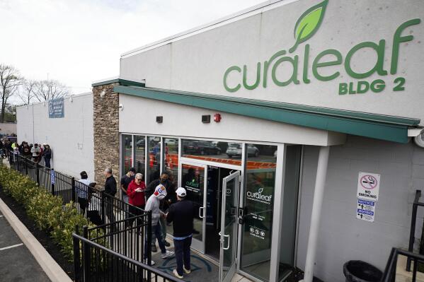 FILE - Customers enter a Curaleaf dispensary on April 21, 2022, in Bellmawr, N.J. One month into existence, New Jersey's recreational marijuana market has done $24 million in sales and regulators on Tuesday, May 24, 2022, voted to grant permits to nearly a dozen new recreational cannabis retailers in their first public meeting since the market opened to the public last month. (AP Photo/Matt Slocum, File)