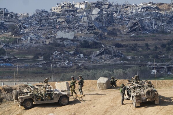 Israeli soldiers take up positions near the Gaza Strip border, in southern Israel, Friday, Dec. 29, 2023.  (AP Photo/Ariel Schalit, File)