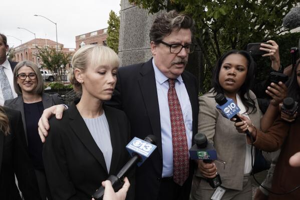 Sherri Papini arrives at the federal courthouse for sentencing accompanied by her attorney, William Portanova, right, in Sacramento, Calif., Monday, Sept. 19, 2022. Federal prosecutors are asking that she be sentenced to eight months in prison for faking her own kidnapping in 2016. (AP Photo/Rich Pedroncelli)