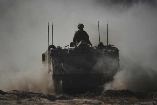 Israeli troops move with APC, armored personnel carrier near the border with Gaza, in southern Israel, Thursday, May 8, 2025. (AP Photo/Ariel Schalit)