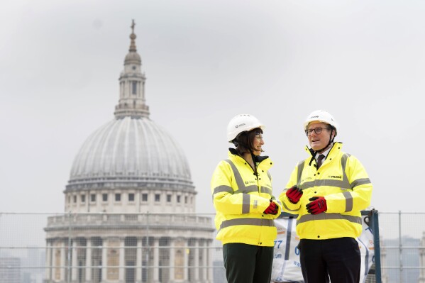 Labour leader Sir Keir Starmer, right, and shadow chancellor Rachel Reeves meet construction workers and apprentices during their visit to Panorama St Paul's, which is to be the new headquarters of the HSBC offices, in London, Thursday, March 7, 2024. Leading British economic think tanks are warning that whoever wins the country’s general election this year will face some very tough choices on tax and spending if they want to make sure the public finances don’t deteriorate further. (Stefan Rousseau/PA via AP)