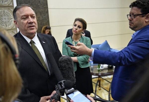 U.S. Secretary of State Mike Pompeo speaks to the media before departing from al-Bateen Air Base in Abu Dhabi, United Arab Emirates, Thursday, Sept. 19, 2019, as State Department spokesperson Morgan Ortagus, second from right, listens. (Mandel Ngan/Pool via AP)
