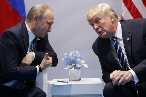 FILE - In this  July 7, 2017, file photo, U.S. President Donald Trump meets with Russian President Vladimir Putin at the G-20 Summit in Hamburg. Putin won’t congratulate President-elect Joe Biden until legal challenges to the U.S. election are resolved and the result is official, the Kremlin announced Monday, Nov. 9, 2020. When Donald Trump won in 2016, Putin was prompt in offering congratulations, but his spokesman Dmitry Peskov told reporters that this year’s election is different. (AP Photo/Evan Vucci, File)