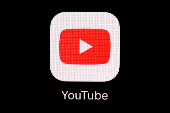 FILE - This March 20, 2018, file photo shows the YouTube app on an iPad in Baltimore. YouTube is rolling out new rules for AI content, Tuesday, Nov. 14, 2023, including requiring creators to reveal whether they've used generative artificial intelligence to make realistic looking videos. (AP Photo/Patrick Semansky, File)