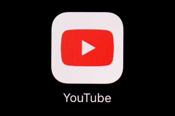 FILE - This March 20, 2018, file photo shows the YouTube app on an iPad in Baltimore. YouTube is rolling out new rules for AI content, Tuesday, Nov. 14, 2023, including requiring creators to reveal whether they've used generative artificial intelligence to make realistic looking videos. (AP Photo/Patrick Semansky, File)